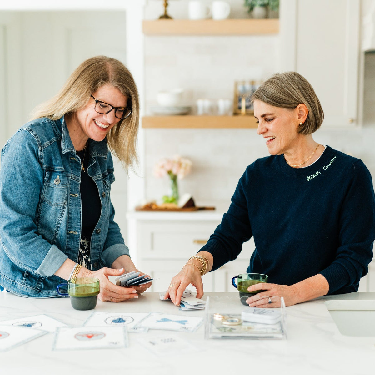 Alonsa Riddle and Natasha Sewell looking at needlepoint thread